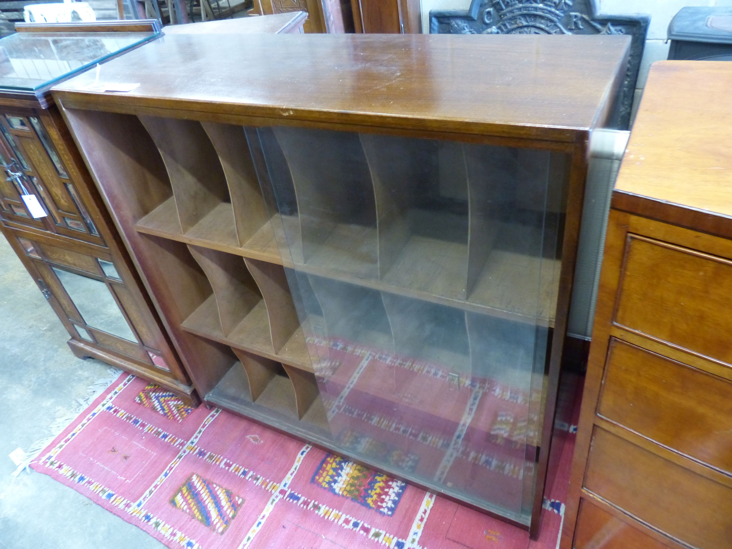 A mid century glazed teak eighteen section record cabinet, length 104cm, depth 35cm, height 104cm